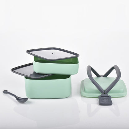 Green plastic bento box with a secure locking system.