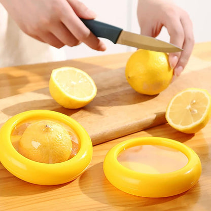 Yellow vegetable and fruit saver with a clear lid, showcasing fresh produce.