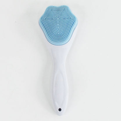 Silicone face scrubber displayed with other skincare products for a complete routine.