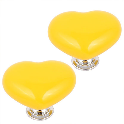 Assortment of colorful heart-shaped cabinet knobs in various shades.
