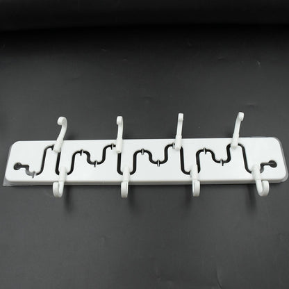 Modern adjustable wall hook installed in a bathroom, holding a towel.