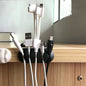 Cable clips organizing multiple wires on a modern wooden desk.