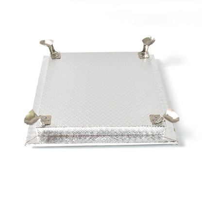 Silver pooja platform with a serene Ganesha carving, ideal for home temples and altars.