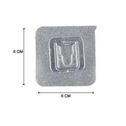 Multiple self-adhesive transparent hooks neatly organized on a surface.