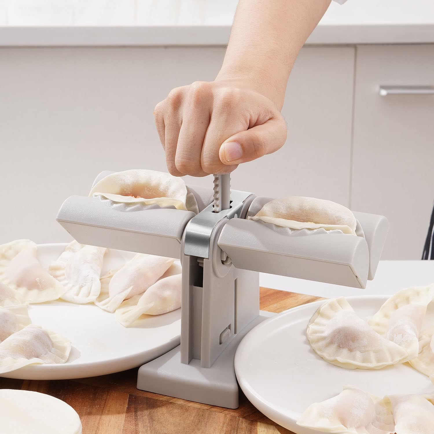 Double head dumpling maker mold in use, creating two perfectly shaped dumplings.