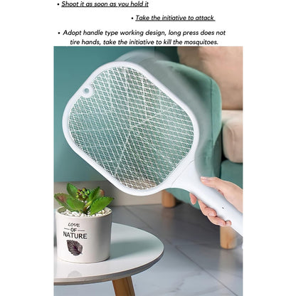 A hand holds a white mosquito killer racket over a small table with a potted succulent, near a green chair.