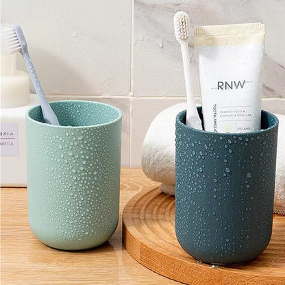 Multipurpose wall mount holder neatly storing toothbrushes, toothpaste, and cups, enhancing bathroom organization.
