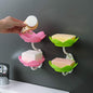White flower-shaped self-draining soap dish holder with suction cup for bathroom use.