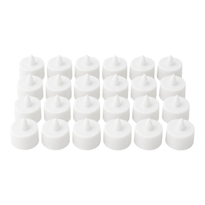 Multiple battery-operated tealights illuminating a dark room.