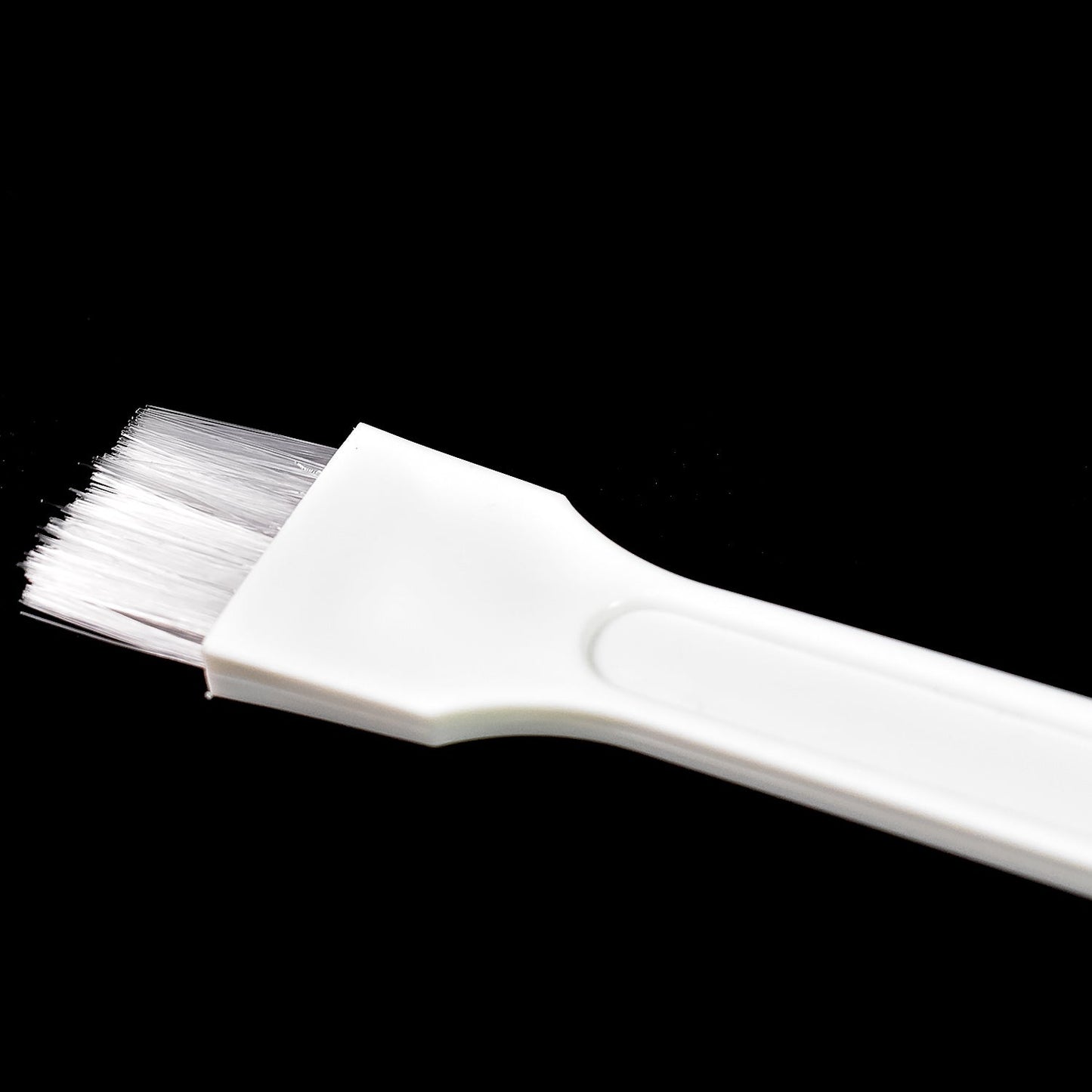 Kitchen cleaning brush reaching into narrow corners.