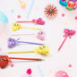Collection of 12 fun cartoon and heart design ballpoint pens with rattles.