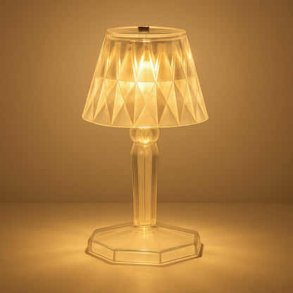 A detailed view of the acrylic crystal table lamp on a wooden surface.