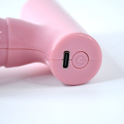 Close-up of the black mini massager's vibrating head for muscle relief.