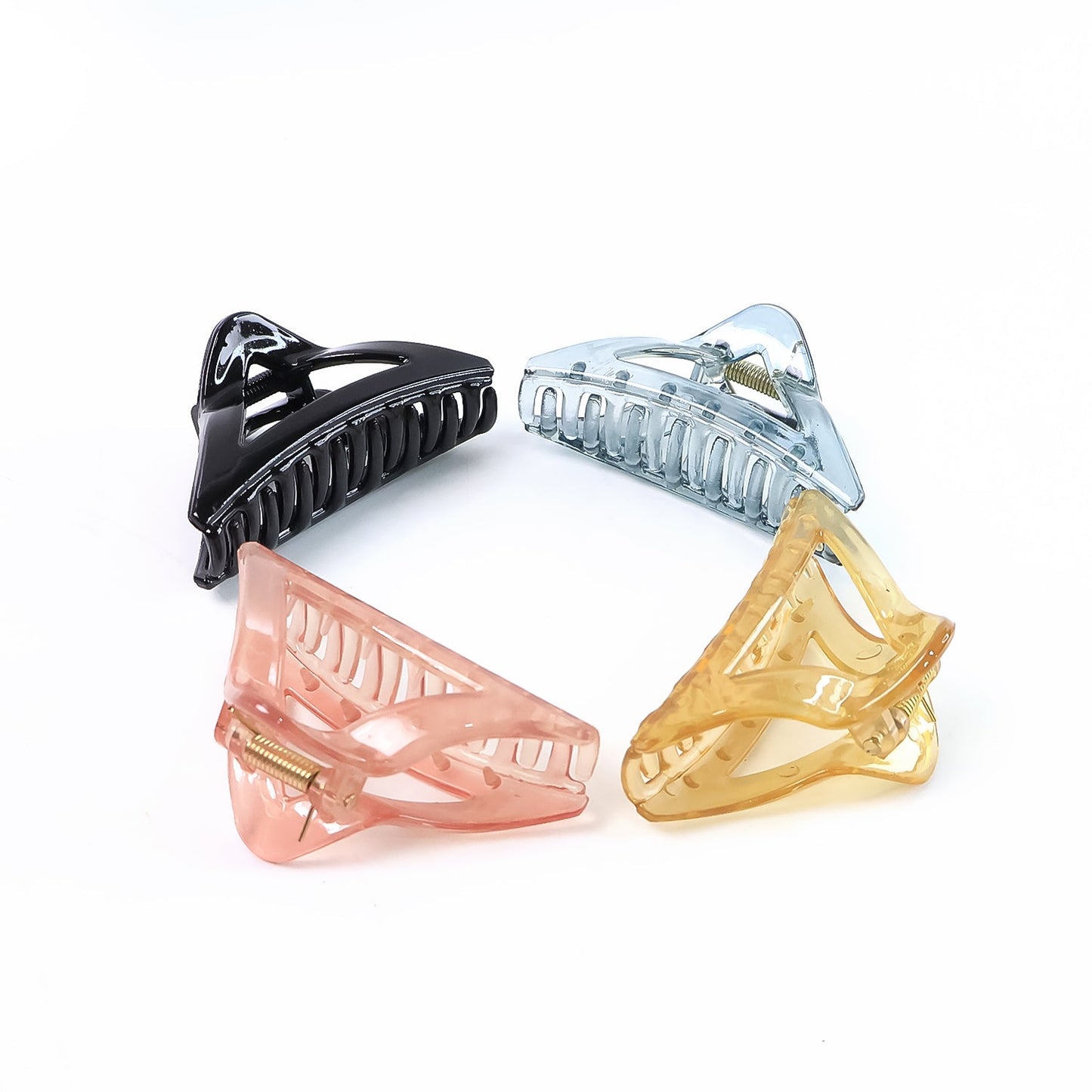 Assorted color triangle plastic hair claw clips laid out for selection