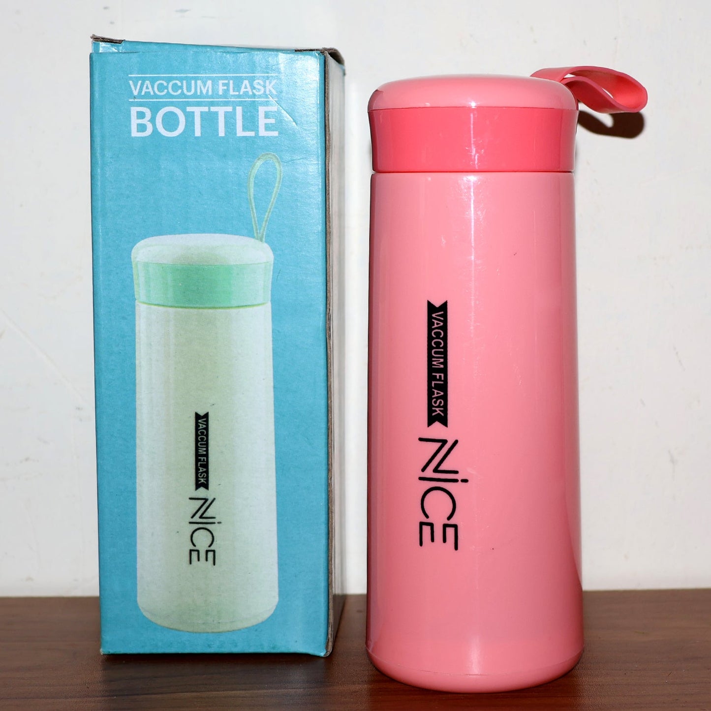 Pink plastic water bottle with leak-proof screw lid and strap