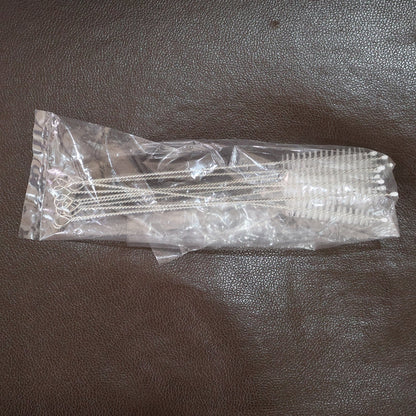 Straw and bottle cleaning brushes with loop handles arranged neatly on a surface