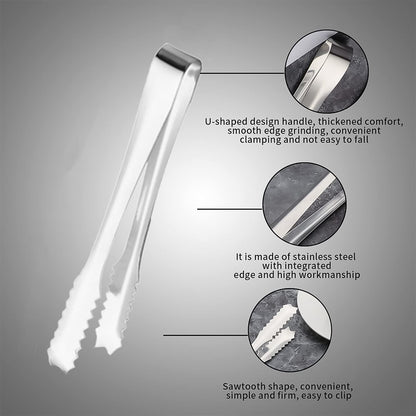 Set of two stainless steel serving tongs on a clear glass plate.