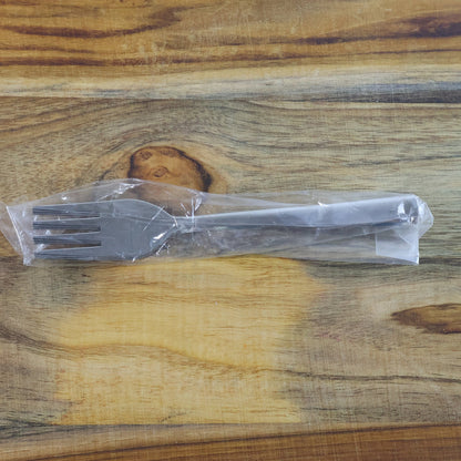 Shiny polished stainless steel dining forks, highlighting their sleek mirror finish.