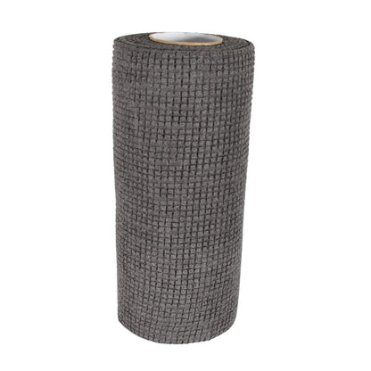 Hand demonstrating the flexible and easy-to-handle kitchen scrub cloth.