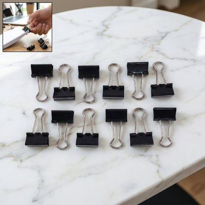 Pile of black metal binder clips 19mm size together