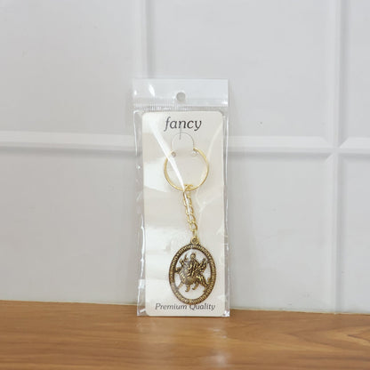 Detailed close-up of premium metal Durga Maa keychain with golden finish