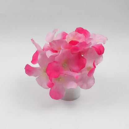 Elegant LED mood light in a glass vase with silk flowers, offering a gentle glow.