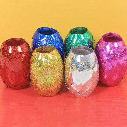 Multicolor curling ribbon rolls displayed for festive party decorations.