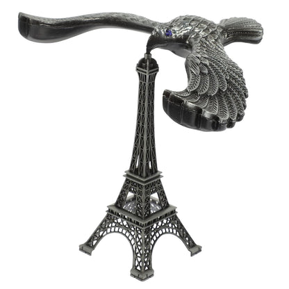 A hand demonstrating the Balancing Eagle Toy's stability by placing it on a fingertip, separate from its stand.
