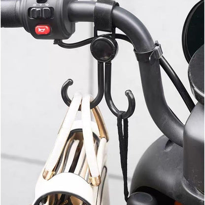 Multi-purpose stroller hook holding shopping bags and a purse on a pram.