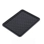 Black anti-skid mat securely holding a phone, keys, and sunglasses on a car dashboard.