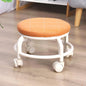 Low height rolling stool in white, designed for easy movement across floors.