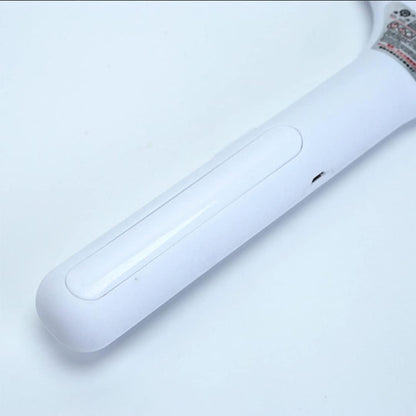 A close-up view of the smooth, white handle of the mosquito killer racket against a plain white background.