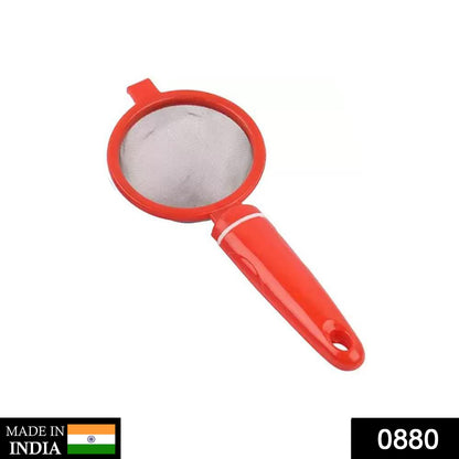 Hand holding a durable plastic tea strainer sieve for everyday kitchen use.