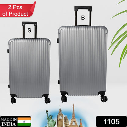 Two hard case trolley bags, big and small, in striking multi-colors, ready for travel.