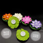 A cluster of multi-color Floating Lotus LED Candles illuminating a water surface during a festive evening.