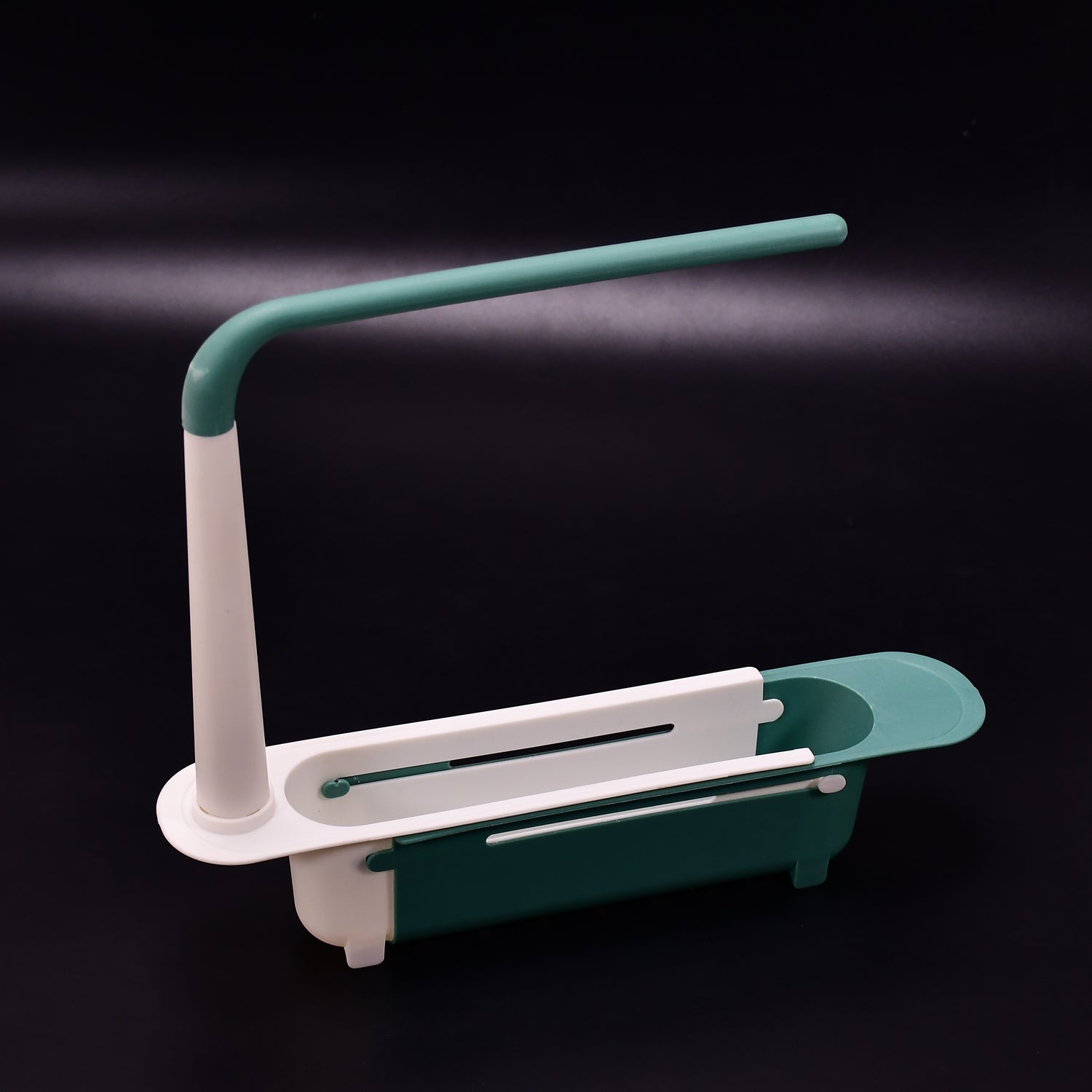 Expandable dish drying rack with a fresh sponge and brush, showcasing its adjustable feature over a sink.