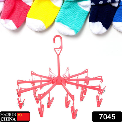 Compact plastic clothes hanger with clips in a folded position, showing portability.