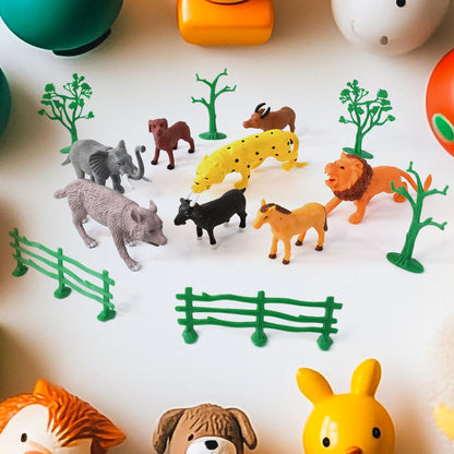 14-piece Animal Kingdom toy set featuring realistic wild animals, trees, and fences