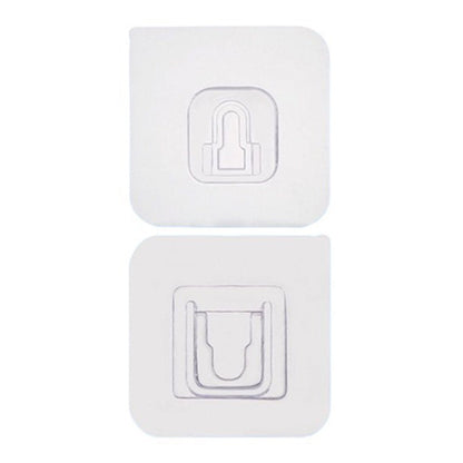 Two white no-drill adhesive hooks mounted on a smooth, clean wall surface.