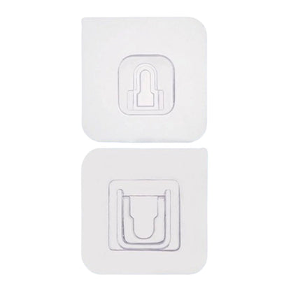 Adhesive wall hooks holding various kitchen utensils, showcasing their versatile use.