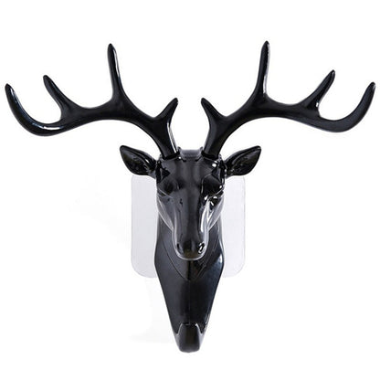 White deer head self-adhesive wall hook attached to a door, ready for use.