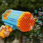 A child happily holds the 69-hole Rechargeable Bubble Gun, blowing a stream of bubbles in a park.