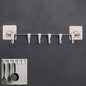 Stainless steel utensil hanger rail with 6 hooks installed on a clean kitchen wall, ready for use.