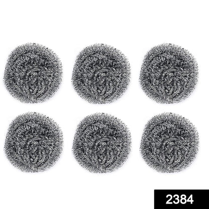 Heavy-duty stainless steel scrubber tackling tough grease on utensils.