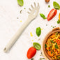 A black plastic pasta fork with serrated edges and a draining hole, ideal for serving spaghetti.