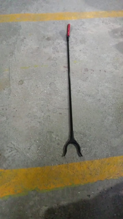 The pick up stick for elderly in a home setting, retrieving an item.
