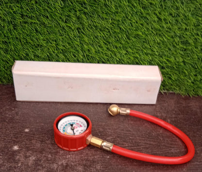 Analog tire inflator gauge clearly showing its PSI and kg/cm² measurement scales.