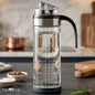 Glass oil dispenser bottle with handle and flip lid for kitchen