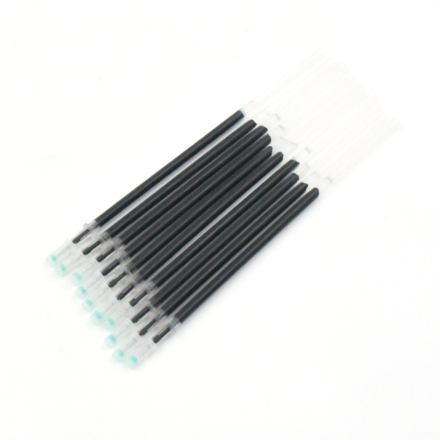 Multiple InkGlow black pen refills arranged neatly on a surface.