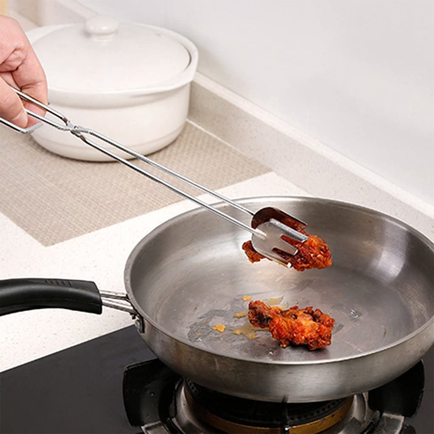 Metal BBQ tongs with an ergonomic handle for comfortable use.